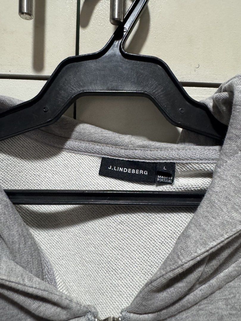 J. Lindeberg Zip-Up Hoodie (Category: Coats, Jackets and Outerwear) located in Paranaque City. Submitted by warmeagle_be0856 (Listing ID 1433056957, Image 2). Description: - J. Lindeberg gray zip-up hoodie - Size: Large - Features: - Hood - Front pockets - Full-length zipper - Subtle pattern on the back - Made in Portugal.
