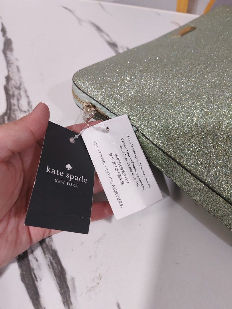 Kate Spade 15" Laptop Sleeve (Category: Laptop Bags & Sleeves) located in Manila. Submitted by oliviavaleria (Listing ID 1433041123, Image 3). Description: - Kate Spade laptop sleeve - Glittery green color - Fits up to 15-inch laptops - Zipper closure - Includes original tags - Light-colored interior - Approximately 16 inches long.
