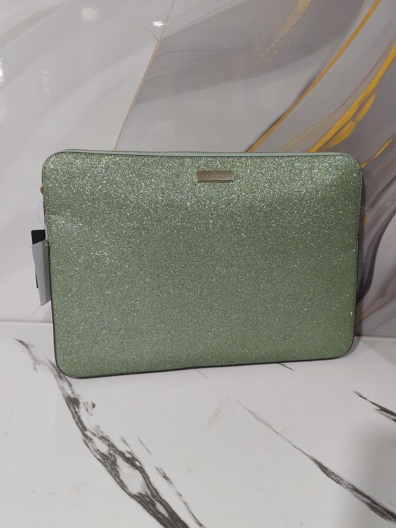 Kate Spade 15" Laptop Sleeve (Category: Laptop Bags & Sleeves) located in Manila. Submitted by oliviavaleria (Listing ID 1433041123, Image 2). Description: - Kate Spade laptop sleeve - Glittery green color - Fits up to 15-inch laptops - Zipper closure - Includes original tags - Light-colored interior - Approximately 16 inches long.