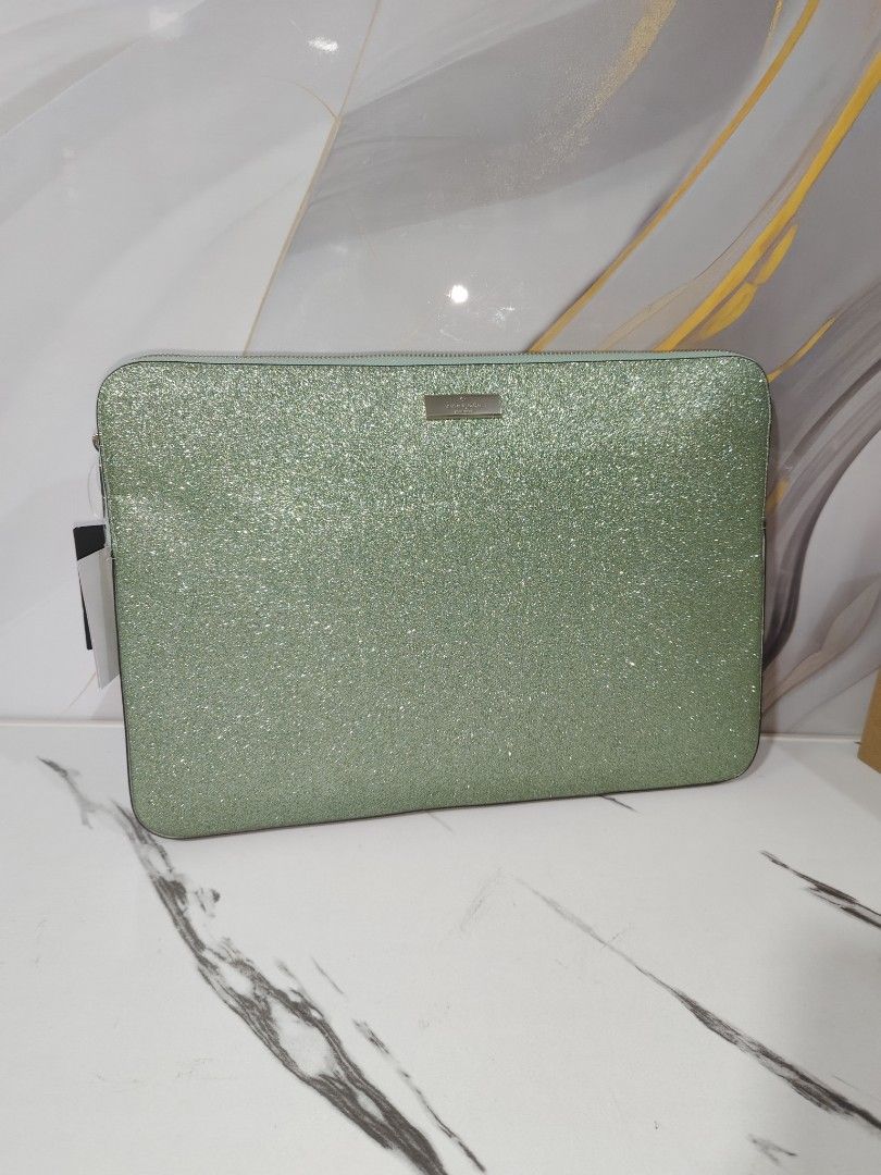 Kate Spade 15" Laptop Sleeve (Category: Laptop Bags & Sleeves) located in Manila. Submitted by oliviavaleria (Listing ID 1433041123, Image 1). Description: - Kate Spade laptop sleeve - Glittery green color - Fits up to 15-inch laptops - Zipper closure - Includes original tags - Light-colored interior - Approximately 16 inches long.