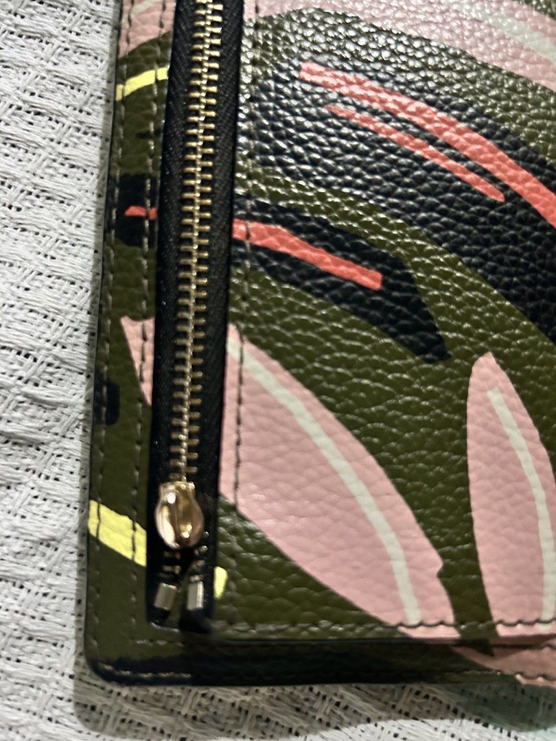 Kate Spade Floral Wallet (Category: Wallets & Card holders) located in Rizal. Submitted by declutter101s (Listing ID 1433044318, Image 3). Description: - Kate Spade floral design wallet. - Features a zip-around closure. - Interior includes multiple card slots and a clear ID window. - Black interior with a snap closure. - Designed with a textured finish..
