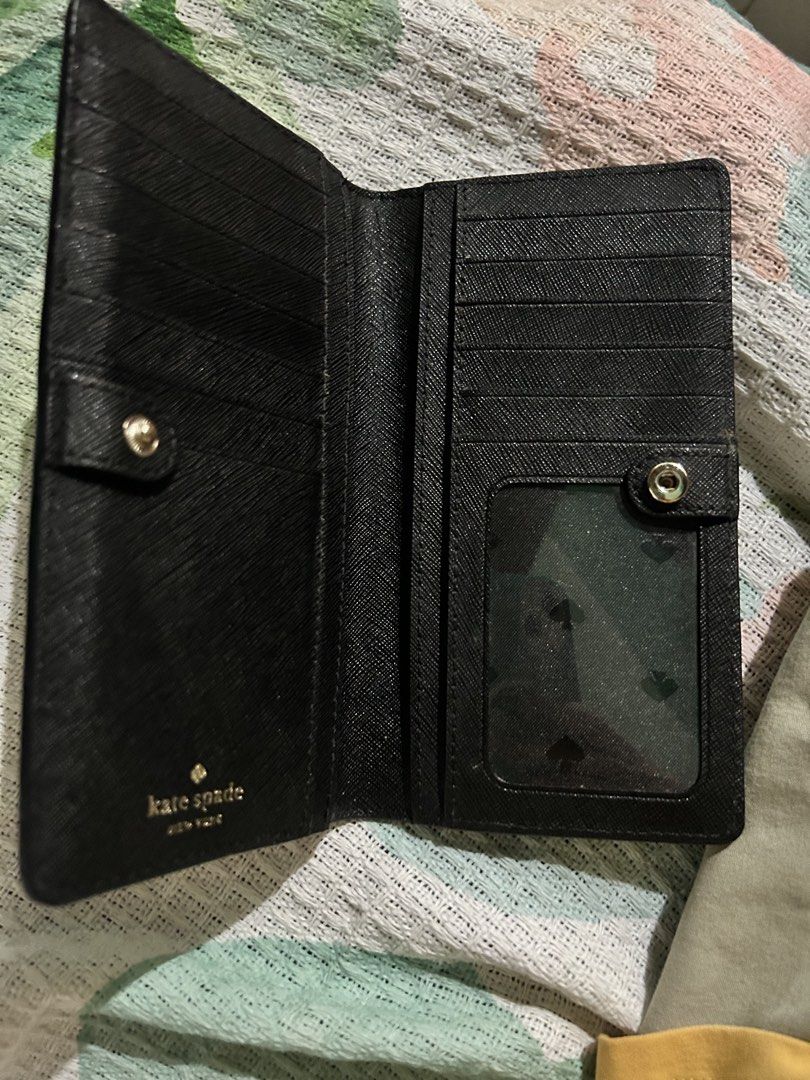 Kate Spade Floral Wallet (Category: Wallets & Card holders) located in Rizal. Submitted by declutter101s (Listing ID 1433044318, Image 2). Description: - Kate Spade floral design wallet. - Features a zip-around closure. - Interior includes multiple card slots and a clear ID window. - Black interior with a snap closure. - Designed with a textured finish..