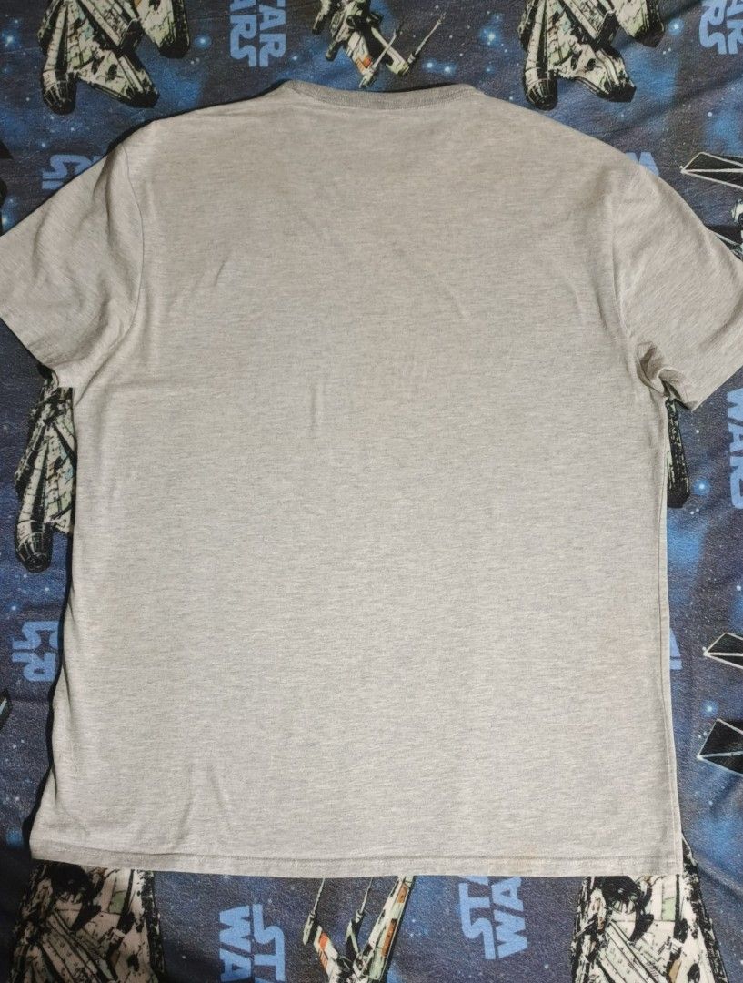 Levi Strauss & Co. Gray T-Shirt (Category: Tshirts & Polo Shirts ) located in Santa Barbara. Submitted by pickersdelight (Listing ID 1433061334, Image 2). Description: - Gray Levi Strauss & Co. t-shirt - Graphic print on front - Short sleeves - Crew neck - Minor hole on one left side - Plain gray back Size: Large Dimension: Width: 21 inches Length: 28 inches Note: colors may vary due to lighting .
