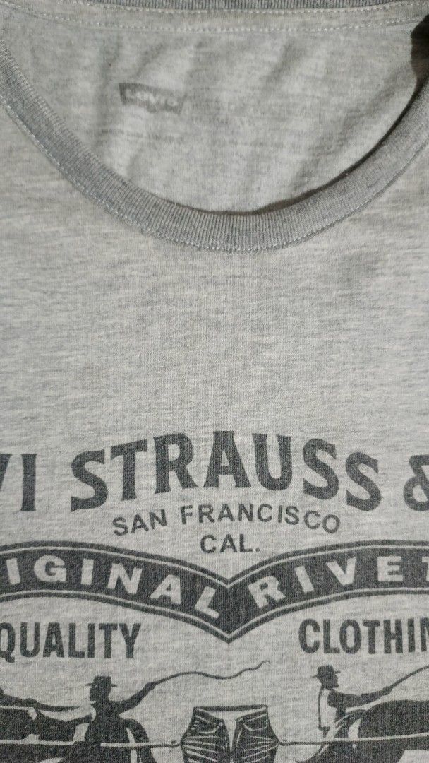 Levi Strauss & Co. Gray T-Shirt (Category: Tshirts & Polo Shirts ) located in Santa Barbara. Submitted by pickersdelight (Listing ID 1433061334, Image 3). Description: - Gray Levi Strauss & Co. t-shirt - Graphic print on front - Short sleeves - Crew neck - Minor hole on one left side - Plain gray back Size: Large Dimension: Width: 21 inches Length: 28 inches Note: colors may vary due to lighting .