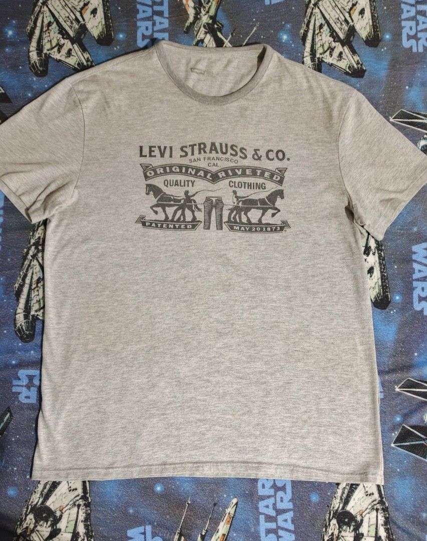 Levi Strauss & Co. Gray T-Shirt (Category: Tshirts & Polo Shirts ) located in Santa Barbara. Submitted by pickersdelight (Listing ID 1433061334, Image 1). Description: - Gray Levi Strauss & Co. t-shirt - Graphic print on front - Short sleeves - Crew neck - Minor hole on one left side - Plain gray back Size: Large Dimension: Width: 21 inches Length: 28 inches Note: colors may vary due to lighting .