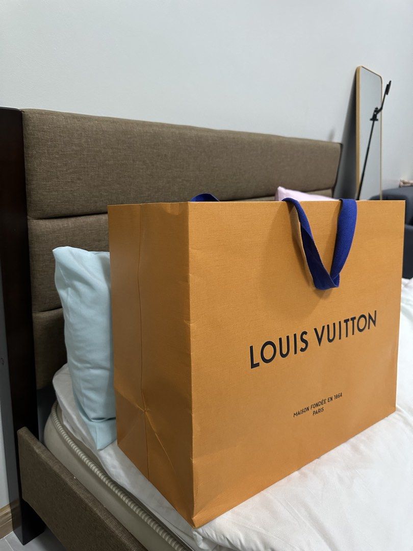 Louis Vuitton Paper Bag XL (Category: Luxury Bags & Wallets) located in Manila. Submitted by luxe_aethel (Listing ID 1433125275, Image 2). Description: - Authentic Louis Vuitton shopping bag - Features the iconic LV logo - Includes "MAISON FONDÉE EN 1854 PARIS" text - Classic orange exterior - Blue handles - Perfect for gifting or collecting.