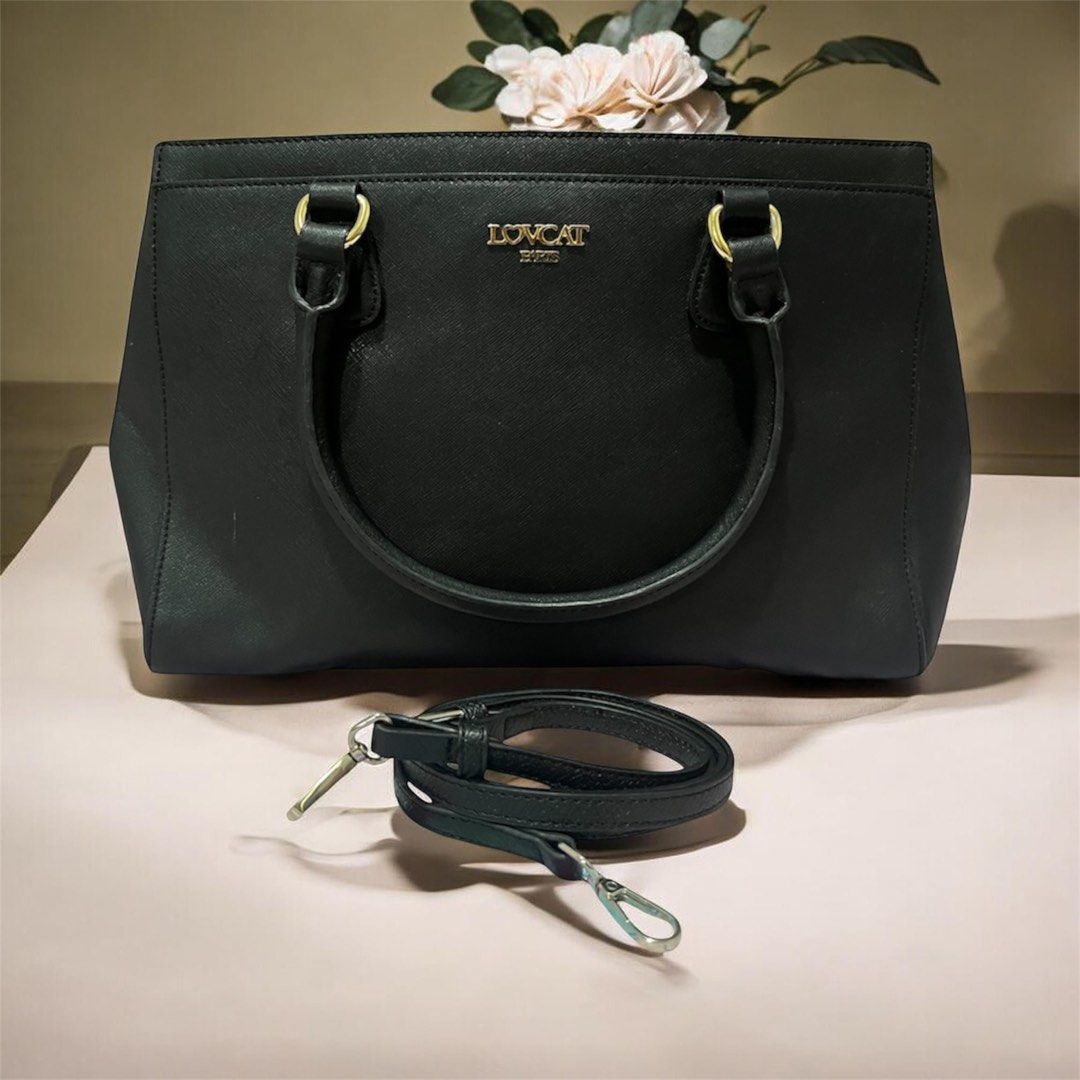 LOVCAT Black 2-way Bag (Category: Luxury Bags & Wallets) located in Las Pinas. Submitted by preloved_koto (Listing ID 1431297375, Image 1). Description: - Black 2-way bag with a top handle and a detachable shoulder strap - Features gold-colored hardware on the handles - It has a rectangular shape with a zipper closure - comes with 3 compartments - Medium size.