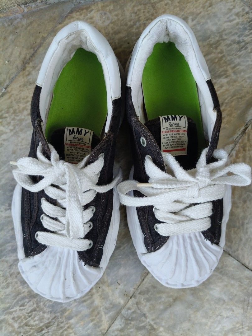 MMY Sneakers Maison Mihara Yasuhiro (Category: Sneakers) located in Tagbilaran City. Submitted by johnmcee (Listing ID 1433100733, Image 2). Description: MMY sneakers in black and white. US10. best fit 9.5. Features a unique design with a white toe cap and sole. The inner sole is green. The brand name is visible on the back of the shoes. The soles have a textured pattern for grip. issue: Replaced insole..