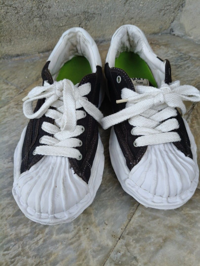 MMY Sneakers Maison Mihara Yasuhiro (Category: Sneakers) located in Tagbilaran City. Submitted by johnmcee (Listing ID 1433100733, Image 1). Description: MMY sneakers in black and white. US10. best fit 9.5. Features a unique design with a white toe cap and sole. The inner sole is green. The brand name is visible on the back of the shoes. The soles have a textured pattern for grip. issue: Replaced insole..