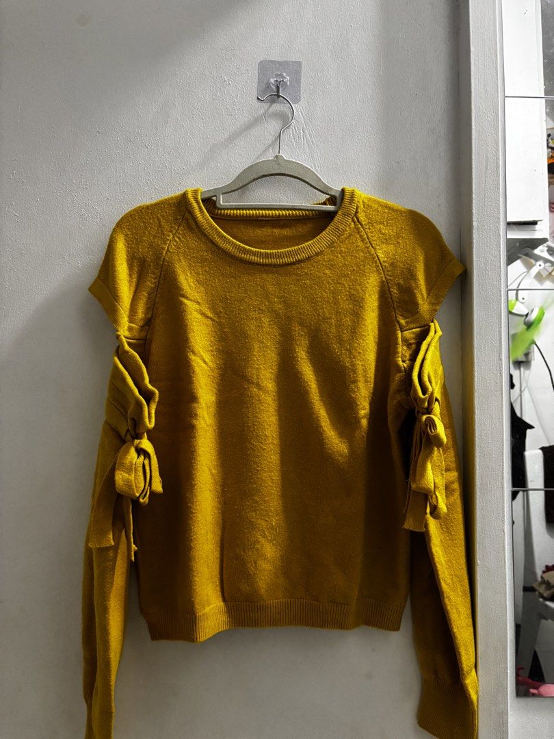 Mustard Yellow Sweater with Bow Sleeves (Category: Longsleeves) located in Quezon City. Submitted by baristaseller (Listing ID 1433119779, Image 2). Description: - Mustard yellow sweater - Unique bow details on sleeves - Round neckline - Long sleeves - Knitted material - Stylish and versatile for various occasions.