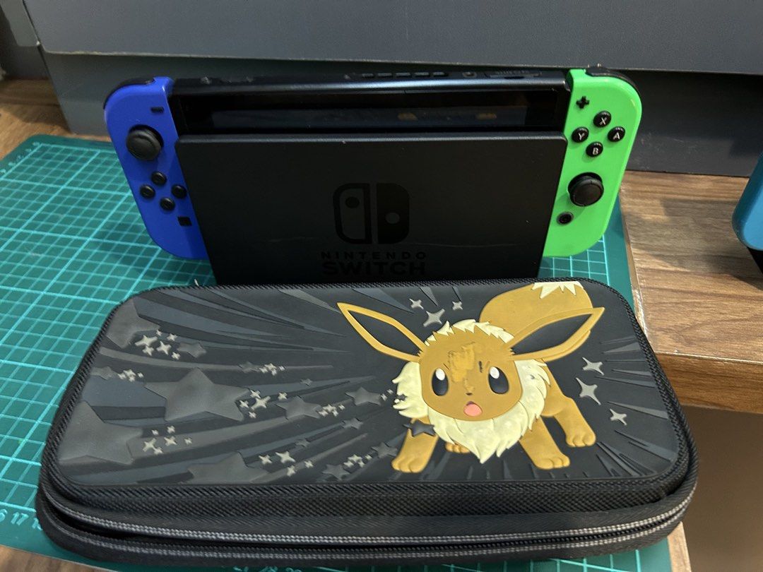 Nintendo Switch Console (Category: Nintendo) located in Muntinlupa City. Submitted by diamond_kd (Listing ID 1433015006, Image 1). Description: - Nintendo Switch console - Blue and green Joy-Cons - Dock with hdmi cable and original adapter - Joy-Con grip - Carrying case (Eevee design) - Two grips.
