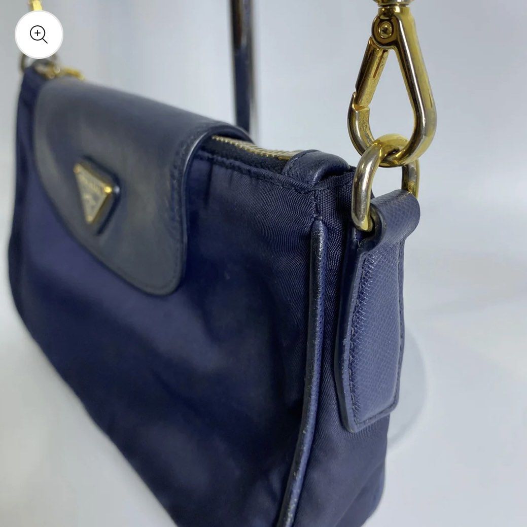Prada Nylon Chain Crossbody Bag (Category: Luxury Bags & Wallets) located in Pasig City. Submitted by _mikha (Listing ID 1433071415, Image 3). Description: - Authentic Prada crossbody bag - Navy blue color - Flap closure with Prada logo - Gold-tone chain strap - Prada-branded interior lining - Includes dust bag - Zipper closure - Small leather detail - Issue: Notable fading on the chain.