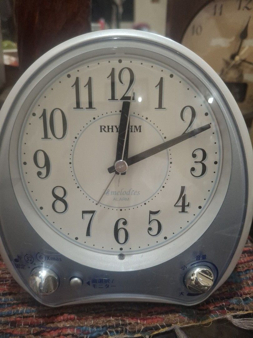 Rhythm Melodies Alarm Clock Japan (Category: Clocks) located in Manila. Submitted by youngcloud_b1fffa (Listing ID 1433177183, Image 1). Description: - Rhythm alarm clock - White face with black numerals and hands - Silver and blue casing - Two side knobs - Speaker on the back - Battery compartment - Displays time - Alarm function "R&B Mix Japan Surplus Items".