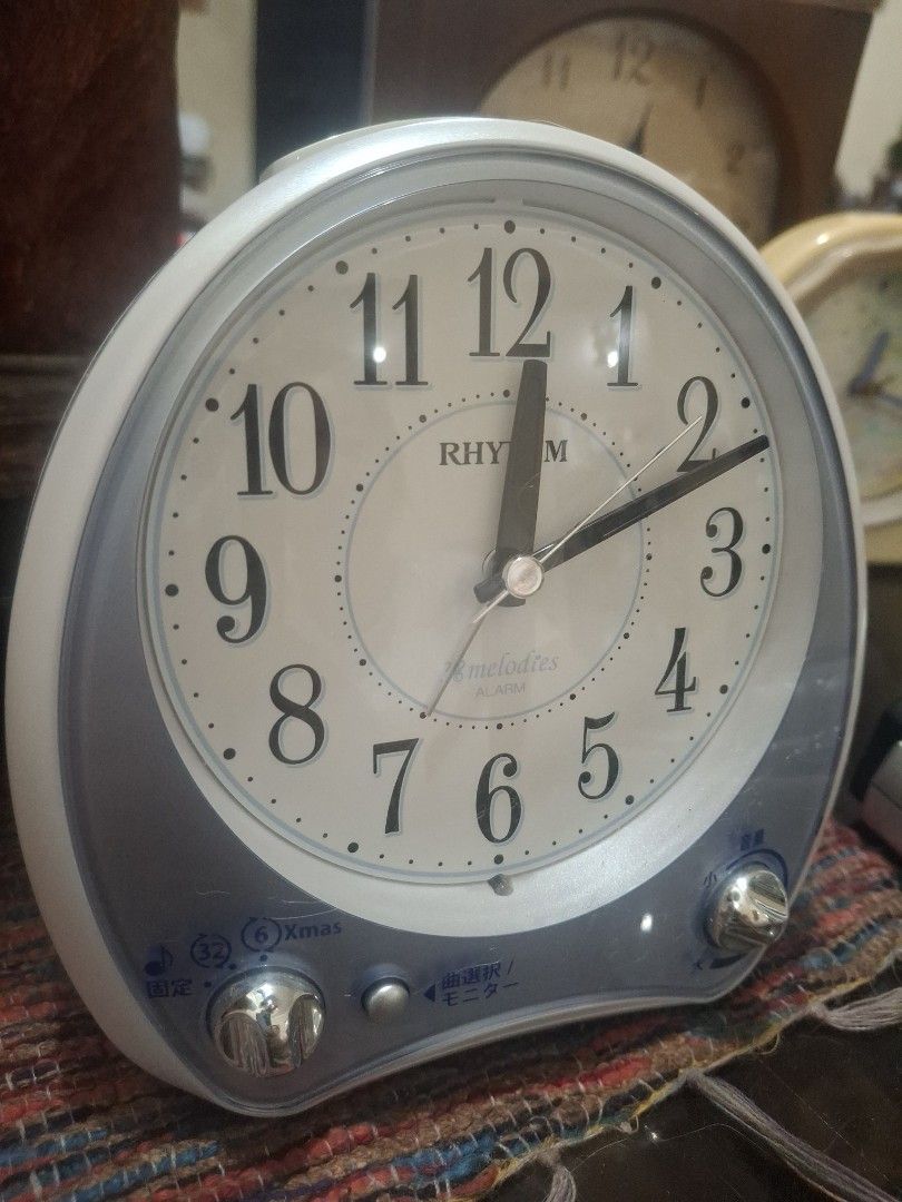Rhythm Melodies Alarm Clock Japan (Category: Clocks) located in Manila. Submitted by youngcloud_b1fffa (Listing ID 1433177183, Image 2). Description: - Rhythm alarm clock - White face with black numerals and hands - Silver and blue casing - Two side knobs - Speaker on the back - Battery compartment - Displays time - Alarm function "R&B Mix Japan Surplus Items".
