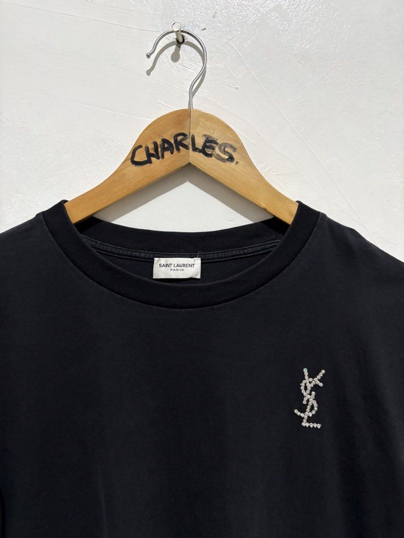Saint Laurent Paris Black T-shirt (Category: Shirts) located in Cabanatuan. Submitted by chingweyyy (Listing ID 1433138355, Image 2). Description: - Authentic Saint Laurent Paris T-shirt - Features the YSL logo on the front - Made in Italy - Crew neck design - Product code: UP73 2022 00342 - Style code: MQ37 487783Y1241 1340 - 21 width 24 length.