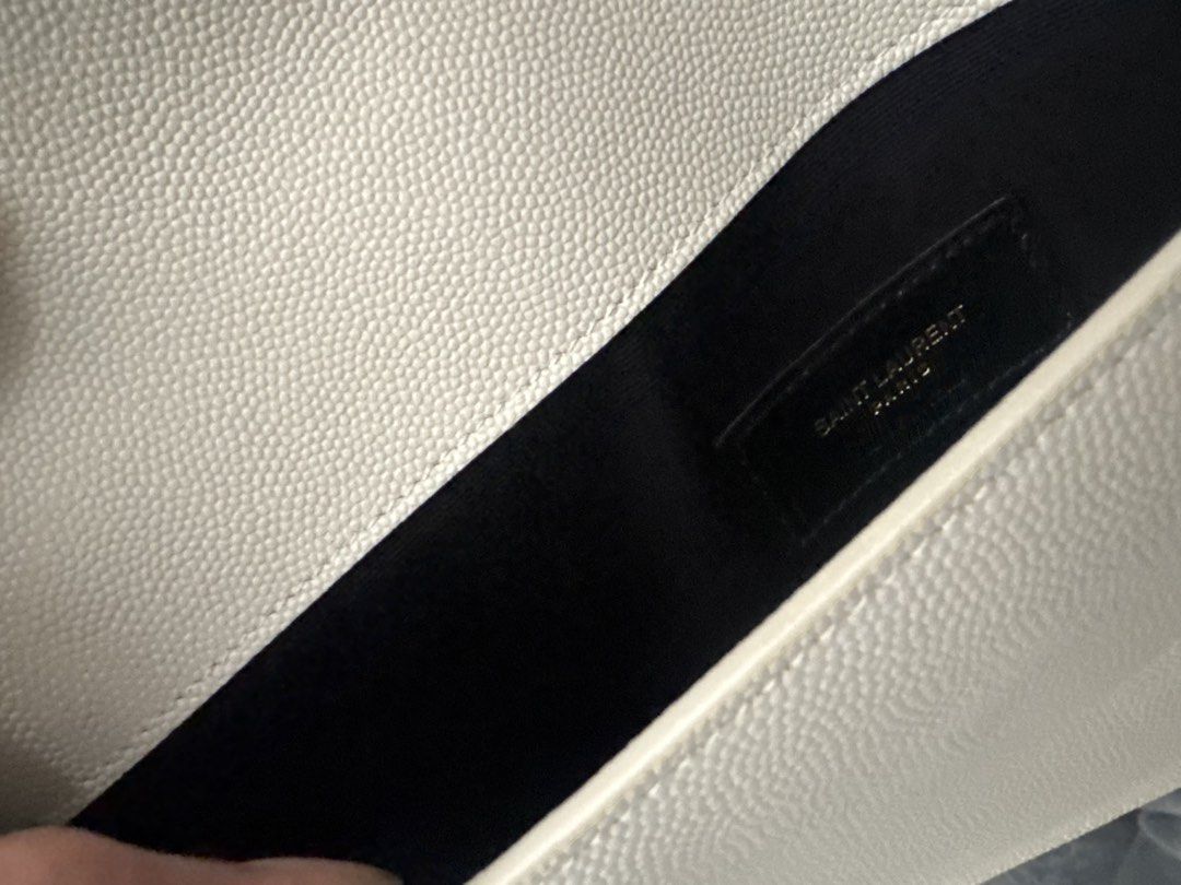 Saint Laurent (YSL) Uptown Envelope Clutch (Category: Luxury Bags & Wallets) located in Taguig. Submitted by czarcloset (Listing ID 1433071205, Image 3). Description: - Personal preloved - Authentic Saint Laurent Envelope Clutch - Cream color - Iconic gold YSL logo - Includes box - Entrupy certificate of authenticity included - Black interior lining with Saint Laurent Paris logo - Perfect for any occasion.