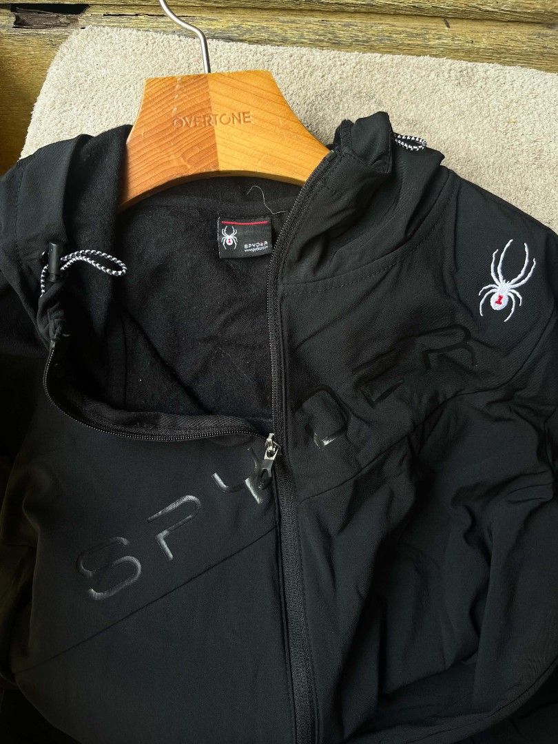 Spyder Black Jacket with Hood (Category: Coats, Jackets and Outerwear) located in Baroy. Submitted by laudecarlfe24 (Listing ID 1433091309, Image 2). Description: - Spyder hooded jacket - Full-length zipper - Two zippered pockets - Spyder logo detail - Water-resistant exterior - Soft interior lining - Includes size tag.