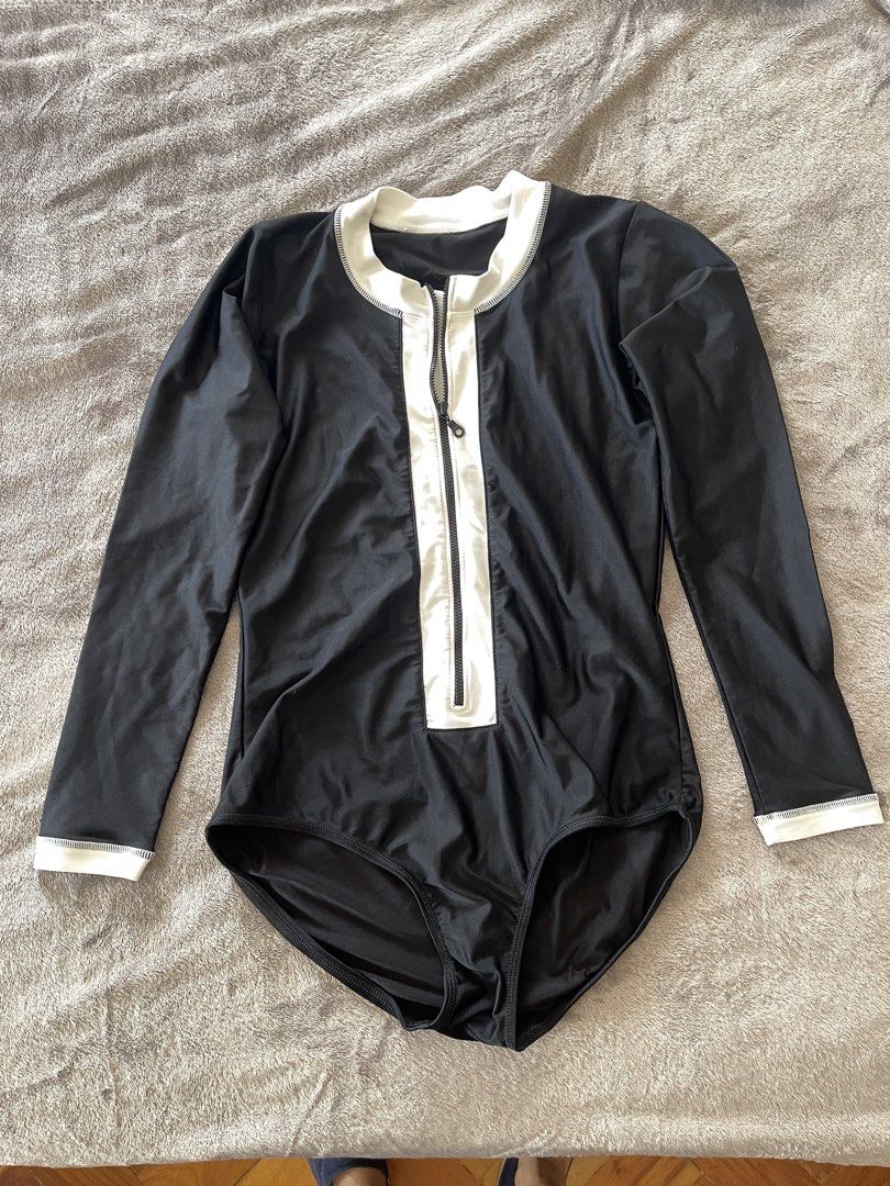 Swimsuit Set - Black and Blue rashguard (Category: Bikinis & Swimsuits) located in Paranaque City. Submitted by lilyandholly (Listing ID 1433024791, Image 2). Description: - Swimsuit set includes: - Black one-piece swimsuit with white zipper and trim - Blue long-sleeved rashguard - Black swimsuit features a high neckline and long sleeves. - Blue top has a logo on the chest. - Made of stretchy material. Fits M-L Lightly used Take all. Not sold sep
