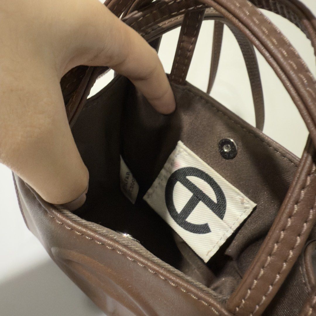 Telfar Shopping Bag Small in Chocolate (Category: Luxury Bags & Wallets) located in Taguig. Submitted by g_declutters (Listing ID 1433116509, Image 2). Description: Well loved and seller's fav! With dust bag. Sourced online for 15k. Rfs: getting a medium size.