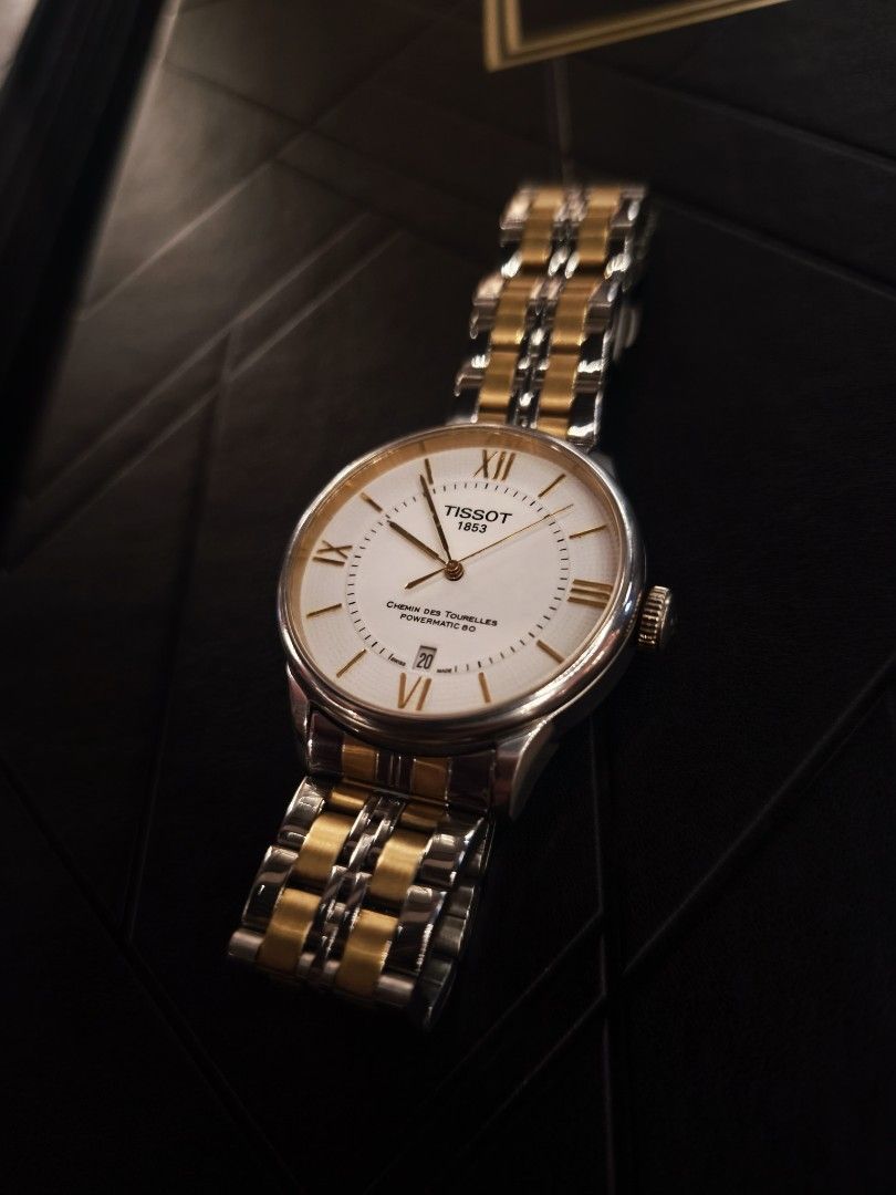 Tissot Chemin des Tourelles Automatic Watch (Category: Luxury Watches) located in Manila. Submitted by vhanlester13 (Listing ID 1433193635, Image 1). Description: - Tissot Chemin des Tourelles Automatic Watch - White dial with Roman numeral hour markers - Date display - Two-tone stainless steel and gold-tone bracelet - See-through case back - Classic design, suitable for any occasion.
