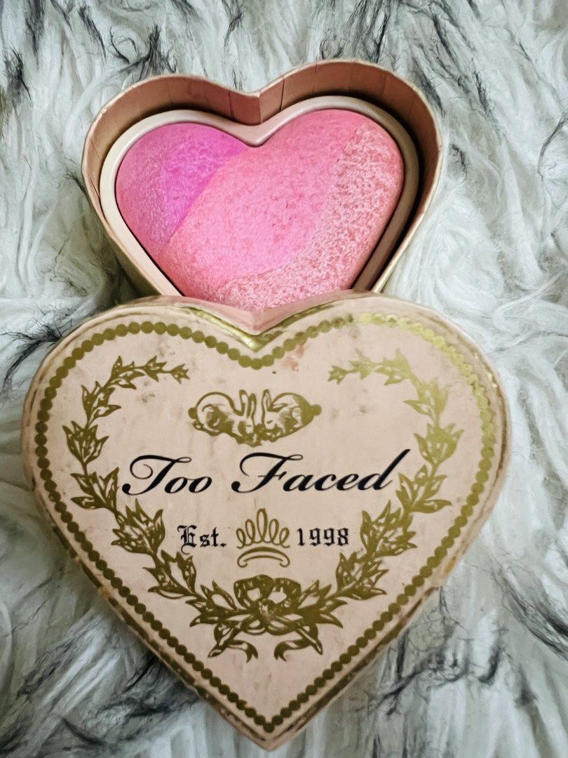 Too Faced Heart Shaped Blush (Category: Makeup) located in Manila. Submitted by kirei2020 (Listing ID 1433015145, Image 3). Description: - Too Faced heart-shaped blush - Gradient of pink shades - Heart-shaped packaging - Gold trim and floral design - Features the Too Faced logo and "1998".