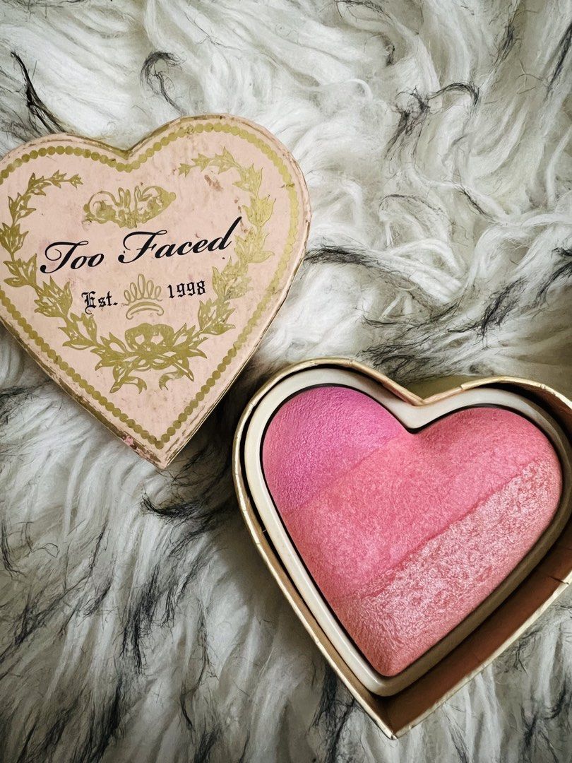 Too Faced Heart Shaped Blush (Category: Makeup) located in Manila. Submitted by kirei2020 (Listing ID 1433015145, Image 2). Description: - Too Faced heart-shaped blush - Gradient of pink shades - Heart-shaped packaging - Gold trim and floral design - Features the Too Faced logo and "1998".
