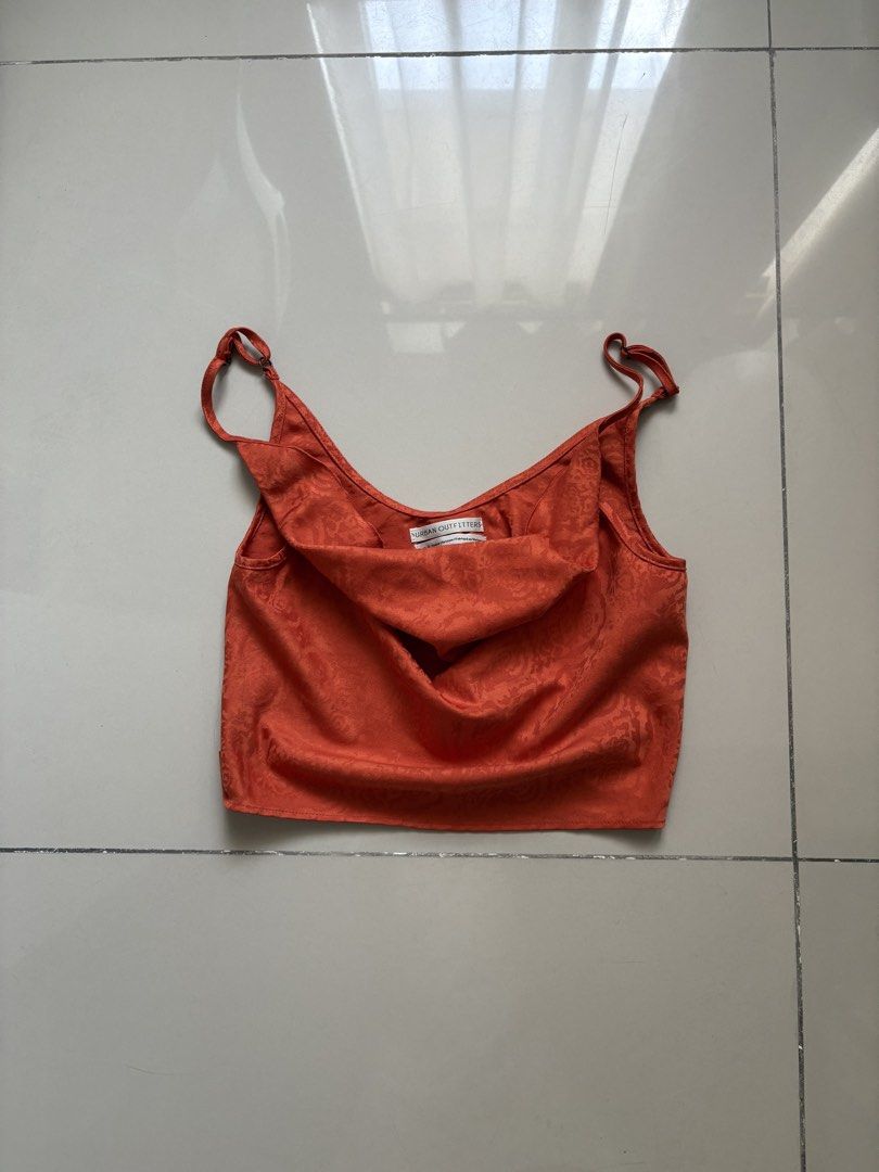 Urban Outfitters Orange Crop Top (Category: Sleeveless) located in Quezon City. Submitted by issa1221 (Listing ID 1433097577, Image 1). Description: - Urban Outfitters crop top - Orange with floral pattern - Spaghetti straps - Stylish and versatile.