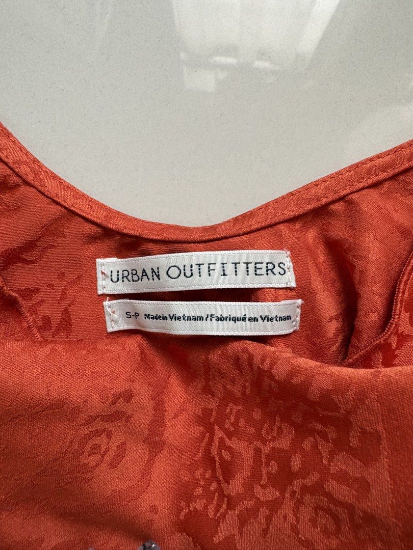 Urban Outfitters Orange Crop Top (Category: Sleeveless) located in Quezon City. Submitted by issa1221 (Listing ID 1433097577, Image 2). Description: - Urban Outfitters crop top - Orange with floral pattern - Spaghetti straps - Stylish and versatile.