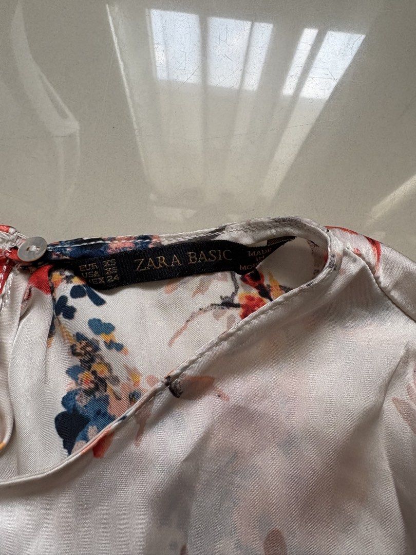Zara Basic Floral Blouse (Category: Blouses) located in Quezon City. Submitted by issa1221 (Listing ID 1433097595, Image 2). Description: - Zara Basic floral blouse - White base with colorful floral pattern - Long sleeves - Round neckline - Small button closure at back - Size: XS.