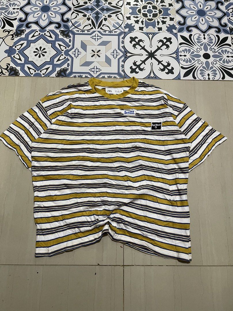 Zara Striped T-shirt (Category: Shirts) located in Manila. Submitted by stuzzygod (Listing ID 1433057428, Image 1). Description: - Zara striped T-shirt - 'Rad Music' patch detail - Color: Yellow, white, and navy blue stripes - Comfortable fabric - Round neckline - Short sleeves - Unique chest patch design - Semi Croftop - Dimes 20*22 - Size Small - Good condition - Color rate 9/10 - No issue.