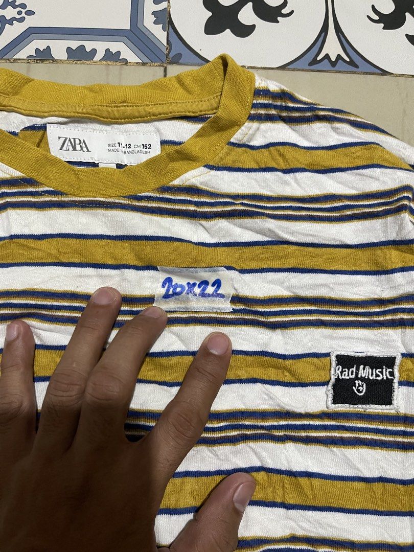 Zara Striped T-shirt (Category: Shirts) located in Manila. Submitted by stuzzygod (Listing ID 1433057428, Image 2). Description: - Zara striped T-shirt - 'Rad Music' patch detail - Color: Yellow, white, and navy blue stripes - Comfortable fabric - Round neckline - Short sleeves - Unique chest patch design - Semi Croftop - Dimes 20*22 - Size Small - Good condition - Color rate 9/10 - No issue.
