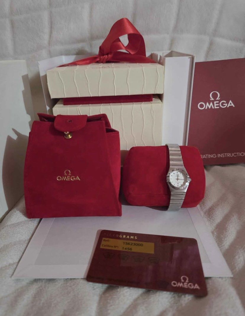 Authentic Omega Constellation Ladies 22MM Watch⌚️ (Category: Luxury Watches) located in Manila. Submitted by luxurycollectionhouse (Listing ID 1429712323, Image 2). Description: Omega Constellation ladies watch. Features a silver dial with Roman numeral hour markers. Includes original box, red pouch, and warranty card. The watch has a stainless steel bracelet. Swiss made..