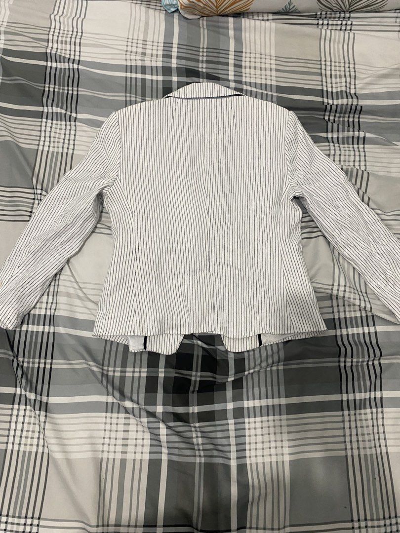 Banana Republic Striped Blazer (Category: Coats, Jackets and Outerwear) located in Manila. Submitted by ceej0915 (Listing ID 1429775535, Image 3). Description: Stylish blazer from Banana Republic. Features a classic striped pattern in white and gray. It has a notched lapel, two front buttons, and buttoned cuffs. The blazer has a tailored fit and is fully lined. Perfect for both casual and formal occasions..