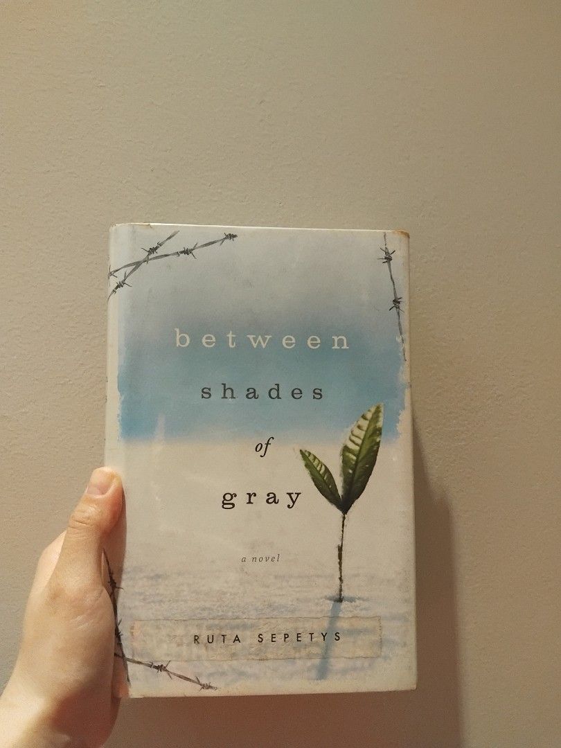 Between Shades of Gray (Category: Storybooks) located in Marikina City. Submitted by danicecedro (Listing ID 1429810531, Image 1). Description: Copy of the novel "Between Shades of Gray" by Ruta Sepetys. The book has a blue and white cover with the title and author's name visible. The back of the book includes a summary and quotes. The pages appear to be slightly yellowed with age. The book is in English..