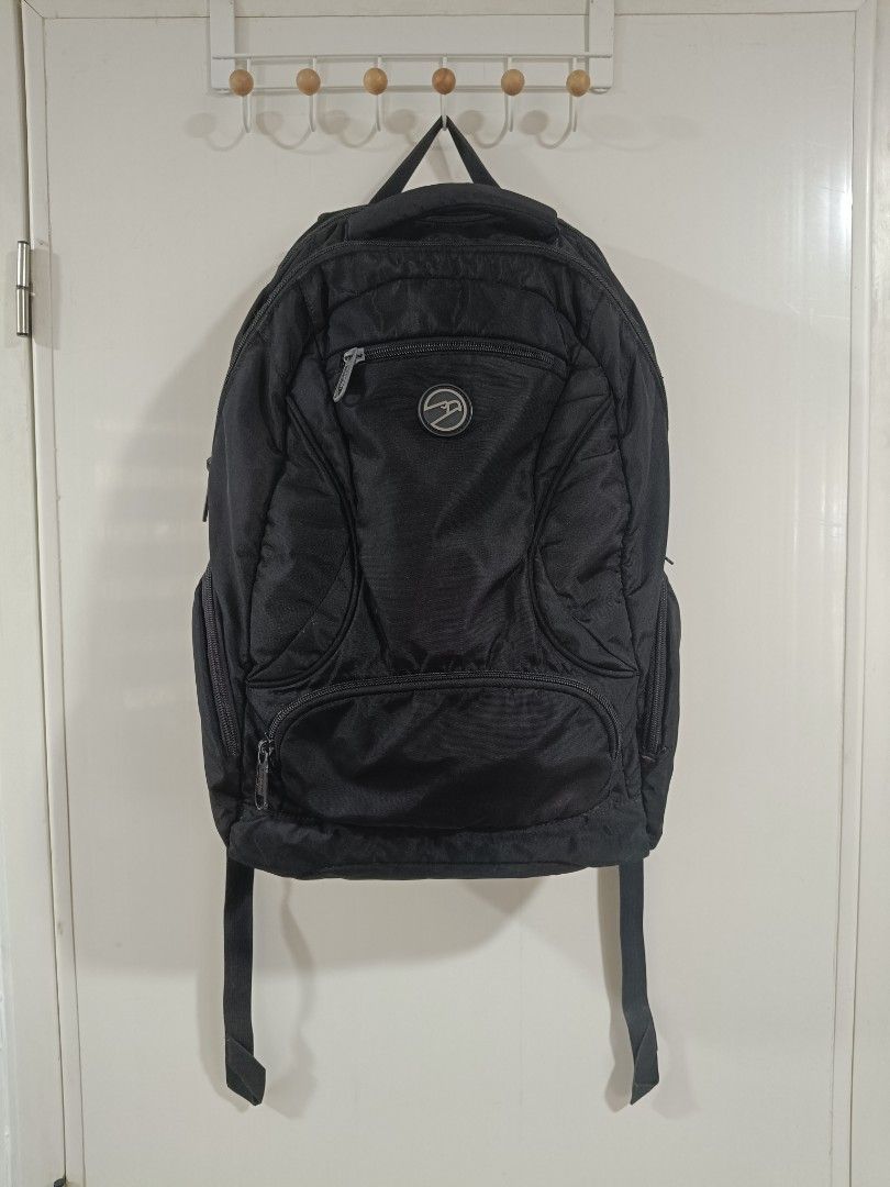 Hawk Black Backpack (Category: Backpacks) located in Iloilo. Submitted by daddy_declutter (Listing ID 1429684881, Image 1). Description: Black backpack with multiple compartments and zippers. Features a logo on the front. Includes adjustable shoulder straps. Suitable for carrying books, laptops, or other essentials..