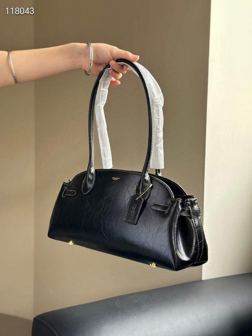 Coach Black Leather Shoulder Bag (Category: Luxury Bags & Wallets) located in Manila. Submitted by directsuppliermla (Listing ID 1429722660, Image 2). Description: Elegant black leather shoulder bag from Coach. Features a sleek design with a top handle and a zip closure. Includes a Coach tag and interior label. The bag has a spacious interior. The bag has gold-toned hardware. Perfect for everyday use or special occasions..