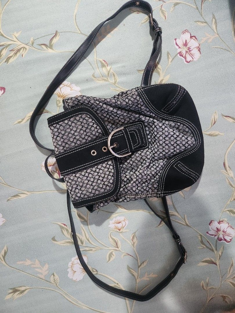 Coach Signature Pattern Crossbody Bag (Category: Luxury Bags & Wallets) located in Makati City. Submitted by itsgonnabemay (Listing ID 1429711170, Image 2). Description: Coach back pack bag features a signature pattern with a black and gray color scheme. It has a flap closure with a buckle and a long adjustable strap. The bag has a main compartment with a zippered pocket inside. The exterior has black accents and white stitching details. .