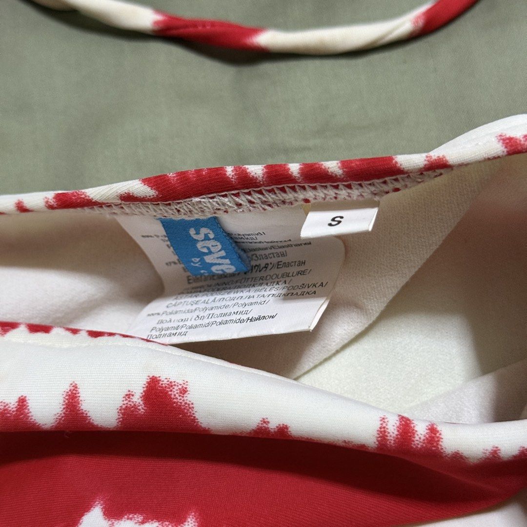 Coral Red and White Bikini Set - Size S (Category: Bikinis & Swimsuits) located in Paranaque City. Submitted by _mrs.j (Listing ID 1429773457, Image 2). Description: Bikini set features a red and white striped pattern. It includes a top with adjustable straps and wooden bead accents, along with matching bottoms. The size is small. The bikini is made of a stretchy material. The top has a tie-up design. The bottoms also have adjustable side ties..