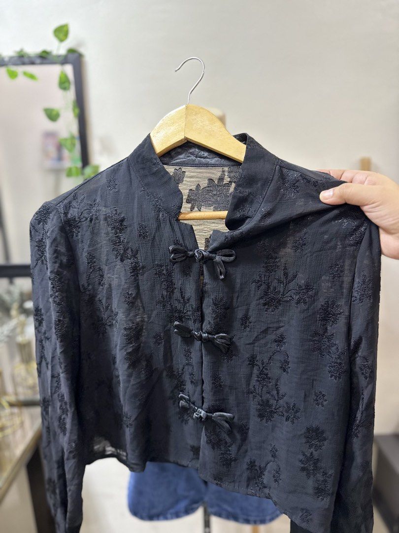 crop Black Embroidered cheongsam Top (Category: Sleeveless) located in Makati City. Submitted by rubis_preloved (Listing ID 1429798584, Image 1). Description: Elegant black top with intricate floral embroidery. Features a mandarin collar and bow closures down the front. The long sleeves add a touch of sophistication. A versatile piece that can be dressed up or down. Perfect for adding a unique touch to any outfit..