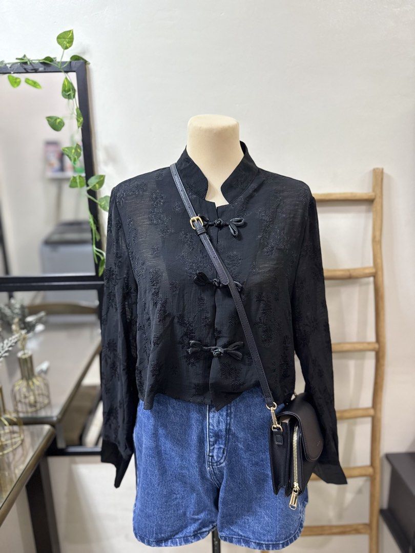 crop Black Embroidered cheongsam Top (Category: Sleeveless) located in Makati City. Submitted by rubis_preloved (Listing ID 1429798584, Image 2). Description: Elegant black top with intricate floral embroidery. Features a mandarin collar and bow closures down the front. The long sleeves add a touch of sophistication. A versatile piece that can be dressed up or down. Perfect for adding a unique touch to any outfit..