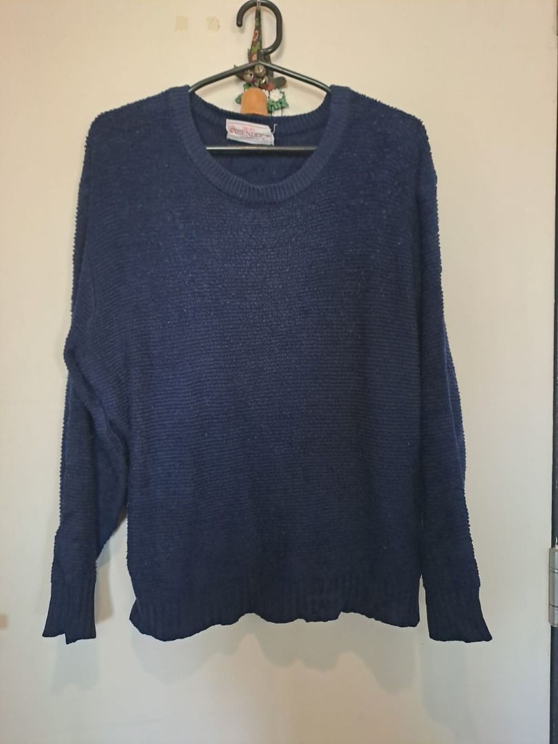 dark blue sweater (Category: Coats, Jackets and Outerwear) located in Mandaluyong City. Submitted by epicowl-c93c (Listing ID 1429746246, Image 1). Description: this is a navy blue crew neck knit sweater with a textured, ribbed-like pattern and dropped shoulders. Key Features Design: The sweater features a wide, relaxed fit with dropped shoulder seams and ribbed cuffs and hem. Fabric: It has a visible textured knit, which is often found in merino