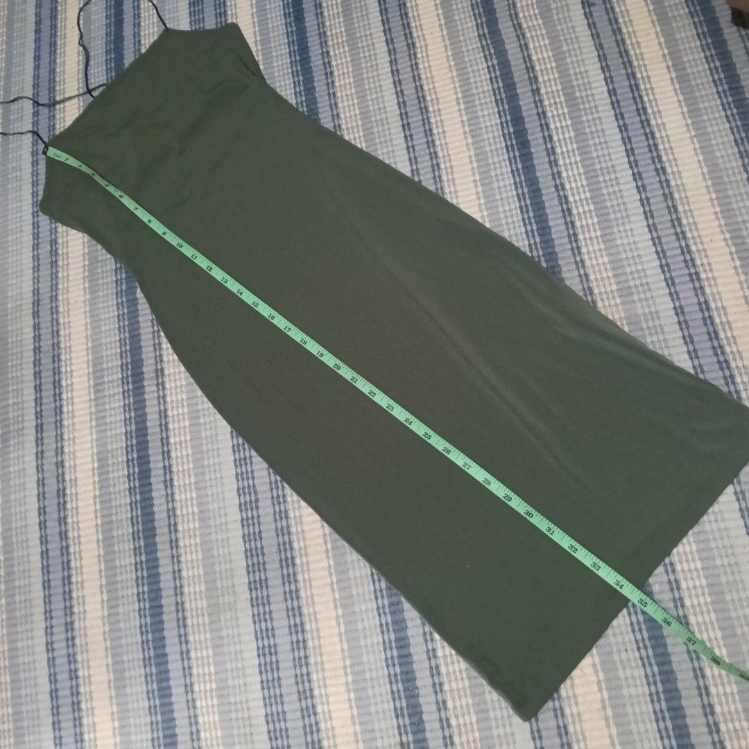 Forever 21 Olive Green Maxi Dress (Category: Dresses) located in Mandaluyong City. Submitted by hailey143 (Listing ID 1429797207, Image 3). Description: Olive green maxi dress from Forever 21. Features spaghetti straps and a fitted silhouette. The dress has a slit at the back. The tag indicates it is a size S. The dress is approximately 50 inches long. The bust measures approximately 14 inches across. Please see attached photos for the measuremen