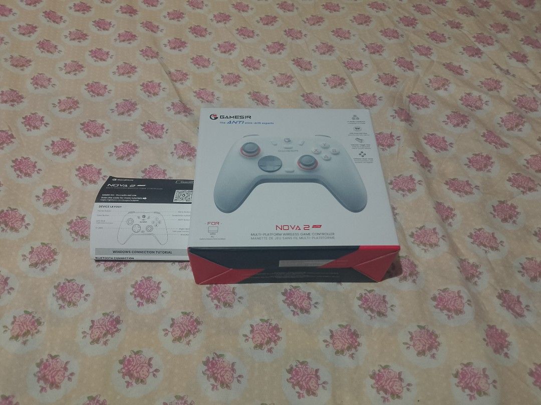 Gamesir Nova 2 Pro Multi-Platform Game Controller (Category: Controllers) located in Manila. Submitted by zenstar-1533 (Listing ID 1429727435, Image 2). Description: Gamesir Nova 2 Pro multi-platform game controller. Includes the controller, box, and manual. The controller is white and gray with red accents. The box shows the controller's features and specifications. The controller has a USB receiver..