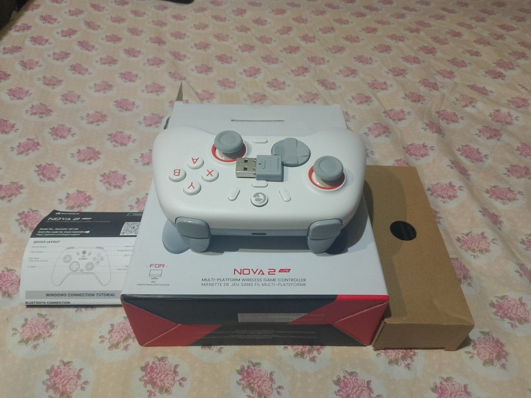Gamesir Nova 2 Pro Multi-Platform Game Controller (Category: Controllers) located in Manila. Submitted by zenstar-1533 (Listing ID 1429727435, Image 1). Description: Gamesir Nova 2 Pro multi-platform game controller. Includes the controller, box, and manual. The controller is white and gray with red accents. The box shows the controller's features and specifications. The controller has a USB receiver..