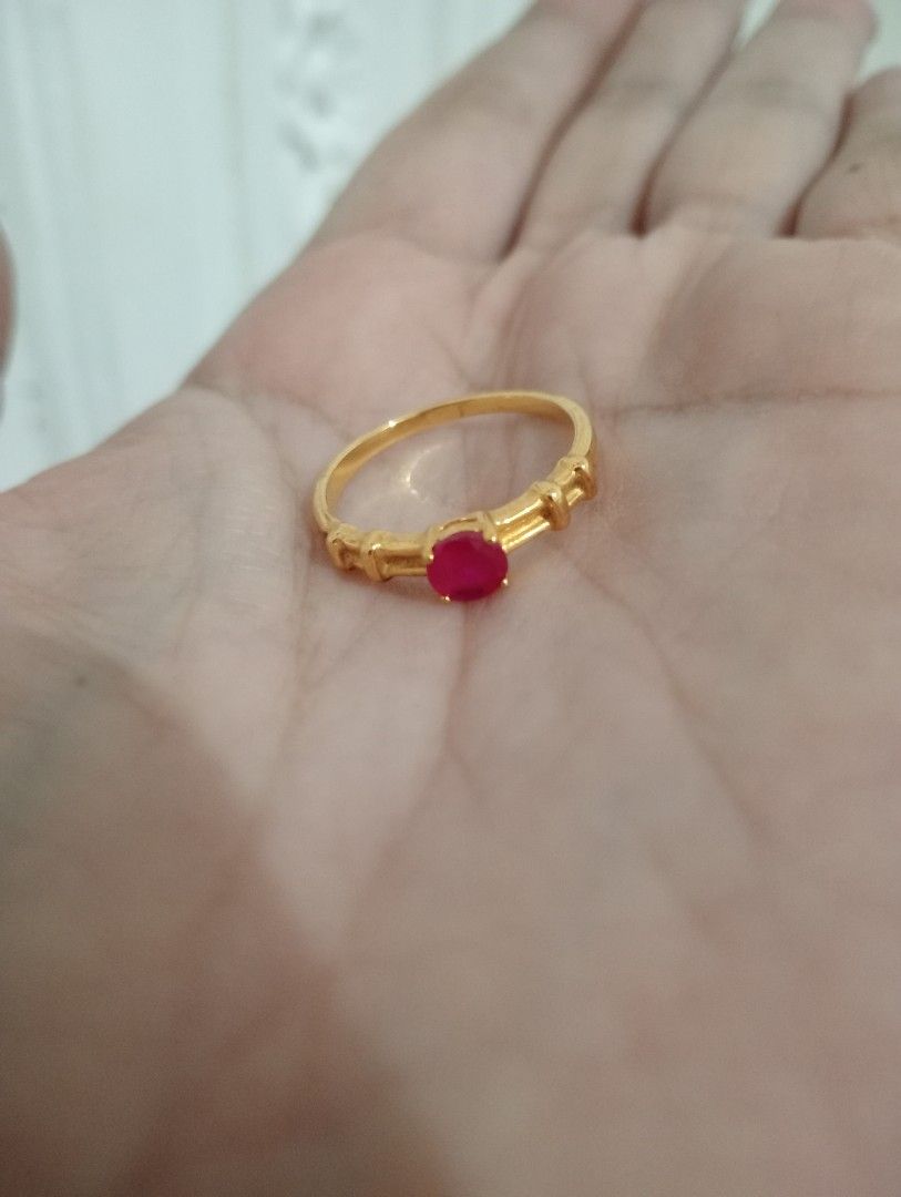 Gold tone Ring with Red ruby Stone (Category: Rings) located in Batangas. Submitted by girlmeetspurple (Listing ID 1429796138, Image 1). Description: Elegant gold ring featuring a vibrant red ruby stone at the center. The ring has a delicate design with decorative elements on the band. The gold band has a polished finish..