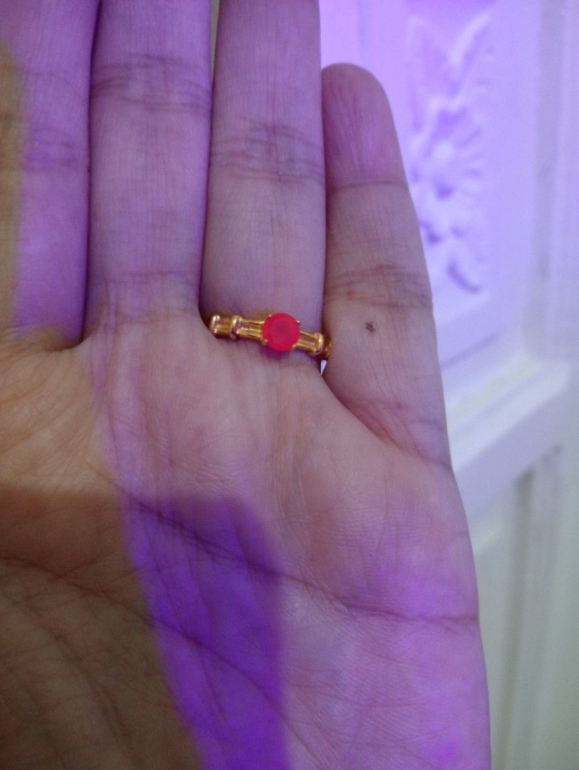 Gold tone Ring with Red ruby Stone (Category: Rings) located in Batangas. Submitted by girlmeetspurple (Listing ID 1429796138, Image 3). Description: Elegant gold ring featuring a vibrant red ruby stone at the center. The ring has a delicate design with decorative elements on the band. The gold band has a polished finish..