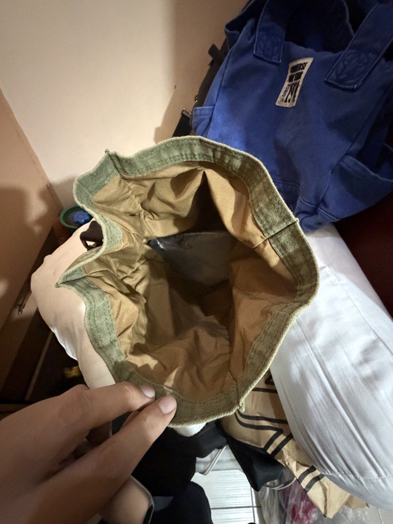 Gouache Canvas Shoulder Bag (lunch box) (Category: Shoulder Bags) located in Paranaque City. Submitted by prelovedlux83 (Listing ID 1429833564, Image 3). Description: Green canvas shoulder bag with a flap closure and adjustable strap. Features a leather accent on the flap and a small brand patch. The bag has a spacious interior. The bag has a brown strap and gold-colored hardware..