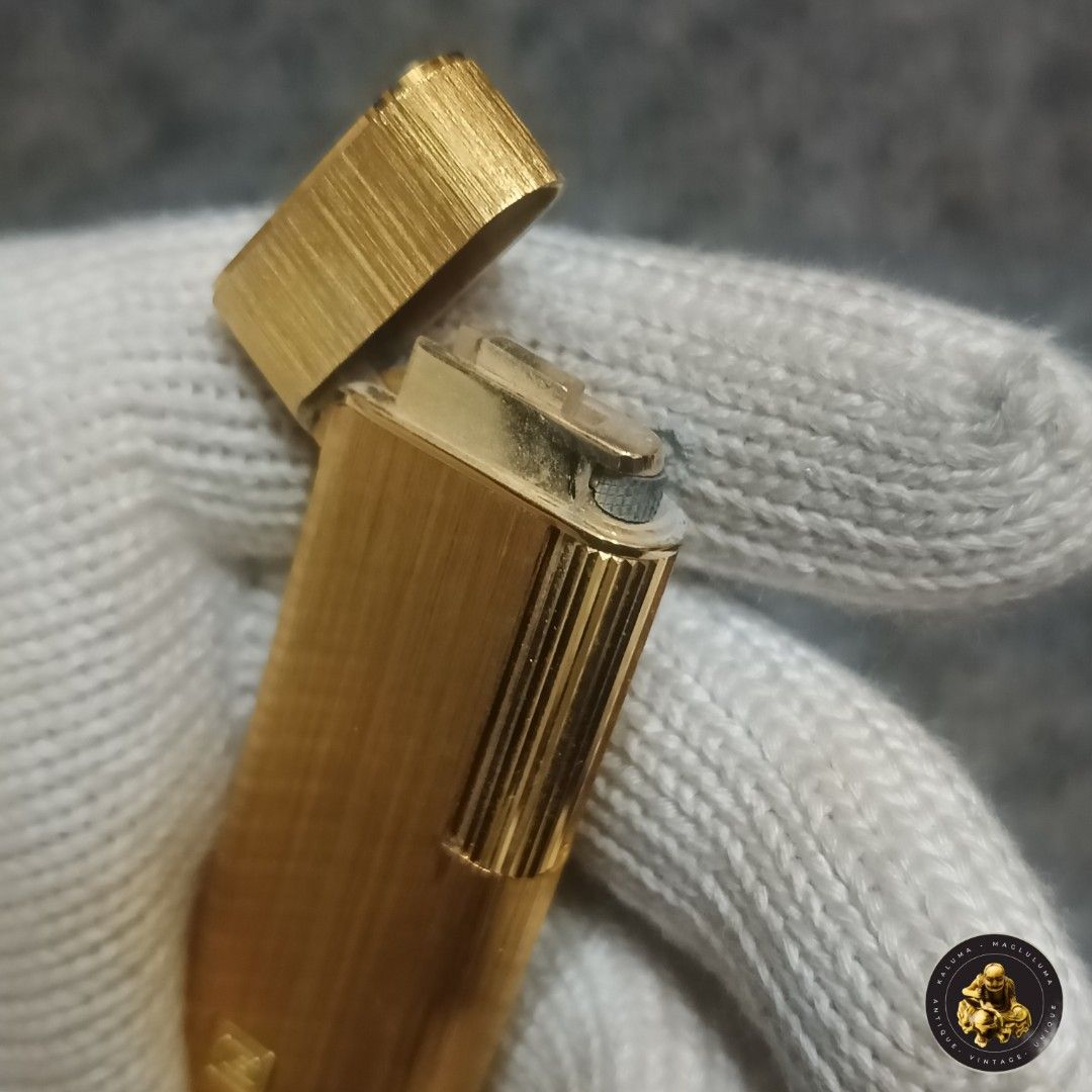 Guy Laroche Gold Lighter (Category: Luxury Accessories) located in Meycauayan. Submitted by ka_luma (Listing ID 1429681173, Image 2). Description: Gold-colored Guy Laroche lighter. The lighter has a rectangular shape with a textured surface. The brand name is visible on the bottom. The lighter's top opens to reveal the ignition mechanism..