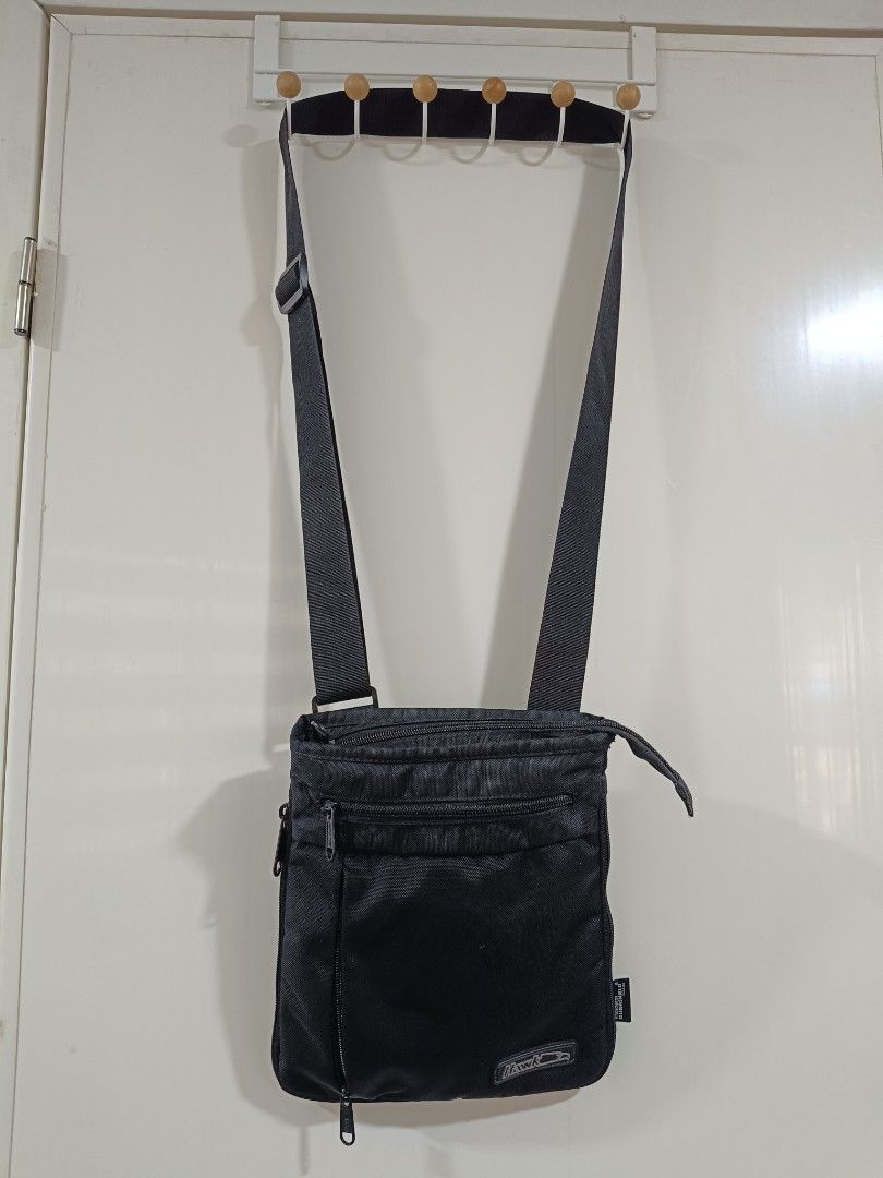 Hawk Crossbody Bag - Black (Category: Backpacks) located in Iloilo. Submitted by daddy_declutter (Listing ID 1429684317, Image 2). Description: Black Hawk crossbody bag. Features a main compartment with a zipper closure, a front zippered pocket, and an adjustable shoulder strap. Includes a small logo patch on the front. Suitable for everyday use..