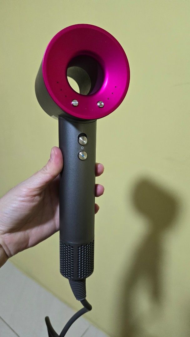 Intelligent High-Speed Hair Dryer (Category: Hair) located in Santa Rosa. Submitted by better.shoppe (Listing ID 1429678911, Image 3). Description: High-speed hair dryer comes with multiple attachments, including a diffuser and various nozzle attachments. The dryer features a sleek design with a pink accent and multiple control buttons. It is packaged in its original box, suggesting it is complete with all accessories. The box indicates it is an 